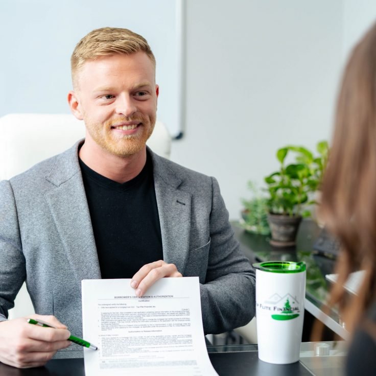 Mortgage lender walking a client through loan benefits